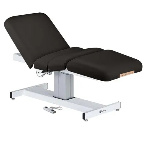 A professional electric lift massage table with a plush padded top, motorized foot pedal control system, and a sturdy adjustable steel frame.