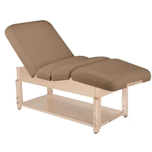 A sturdy professional stationary massage tables built from solid hardwood, featuring a plush padded top, adjustable headrest, and an integrated lower storage shelf.