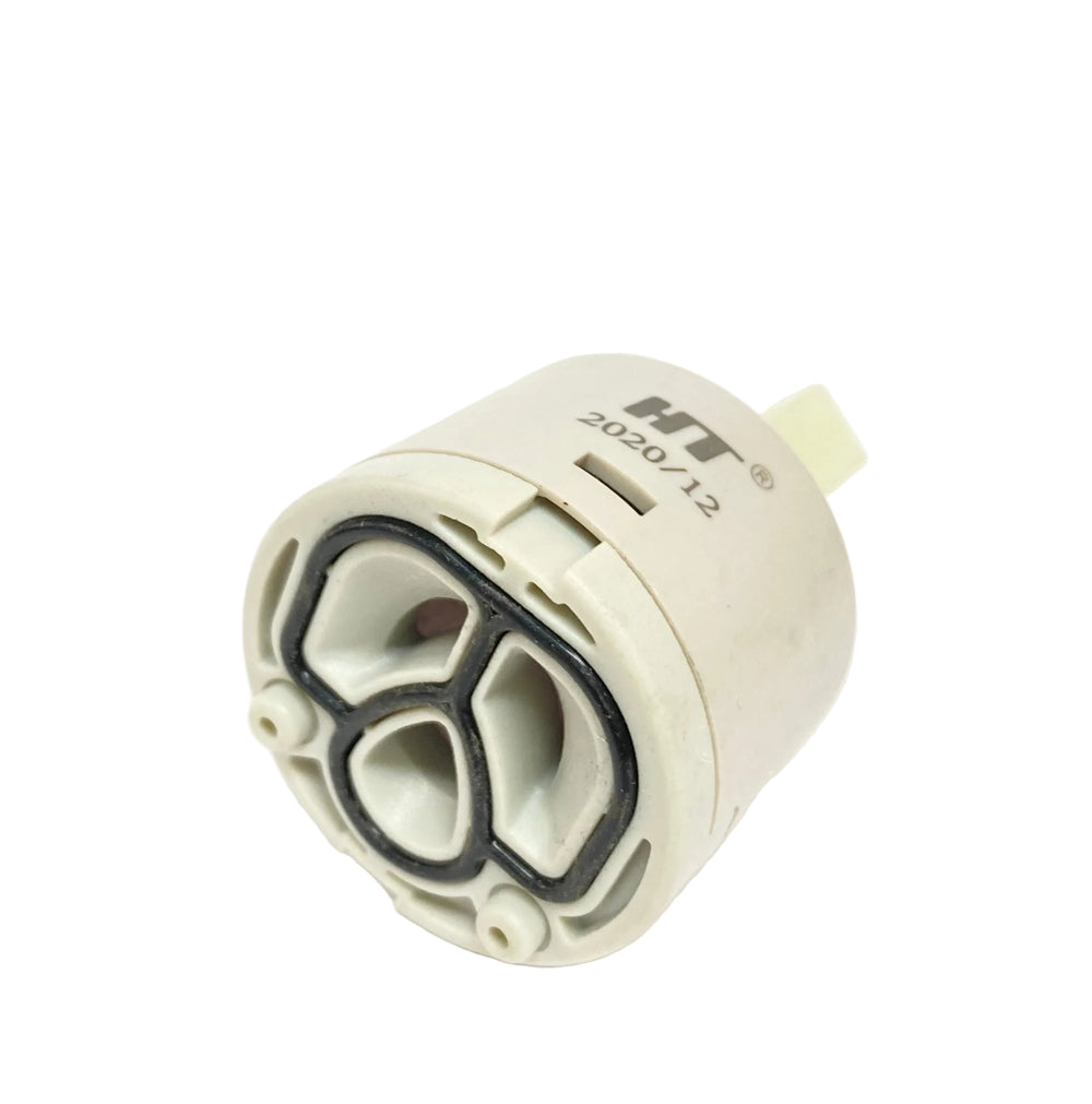A small cylindrical plastic component with a beige body, black gasket, and printed text reading HT 2020/12, photographed on a plain white background.