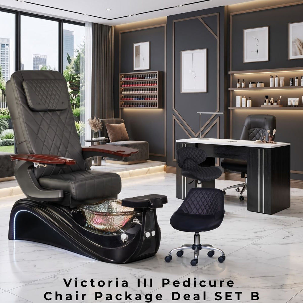 Victoria III Pedicure Chair Package Deal SET B featuring a luxury black leather pedicure chair with a glass basin, a black and white manicure table with a matching black client chair, and two diamond-stitched rolling technician stools in a modern, dark-toned salon interior.