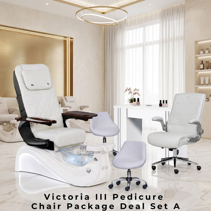Victoria III Pedicure Chair Package Deal Set A featuring a luxury white leather pedicure chair with built-in foot basin, a white manicure table with a matching client chair, and two rolling technician stools in a modern, elegant salon setting.
