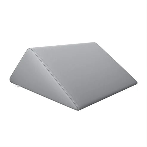 Gray DIR triangular massage wedge bolster for salon and spa tables.